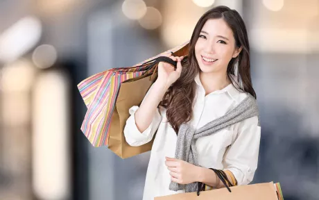 Smiling woman holding shopping bags